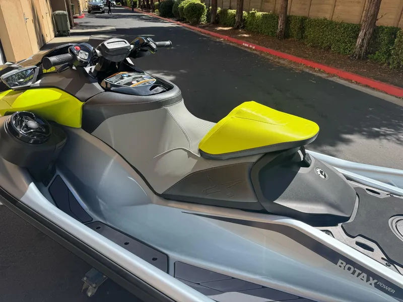 Slide: The Image of 2025 Sea-Doo RXP-X 325 jet ski with vibrant yellow seat, parked outdoors. - 3