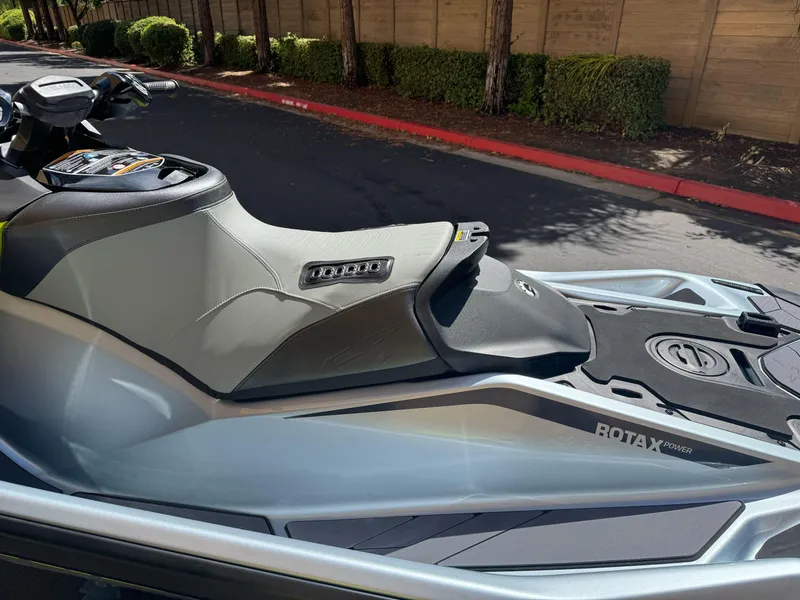 Slide: The Image of 2025 Sea-Doo RXP-X 325 jet ski, sleek design, parked outdoors. - 4