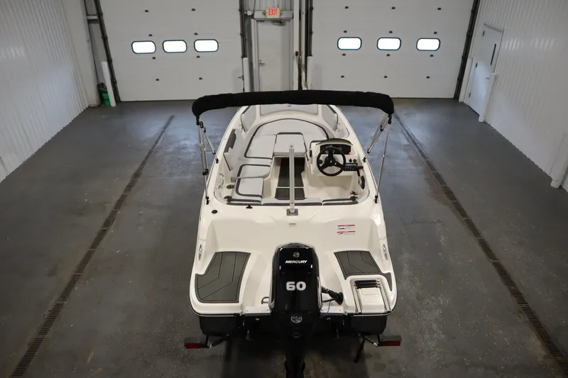 Slide: The Image of 2025 Bayliner M15 MX COMFORT PACKAGE boat in a garage, rear view. - 10