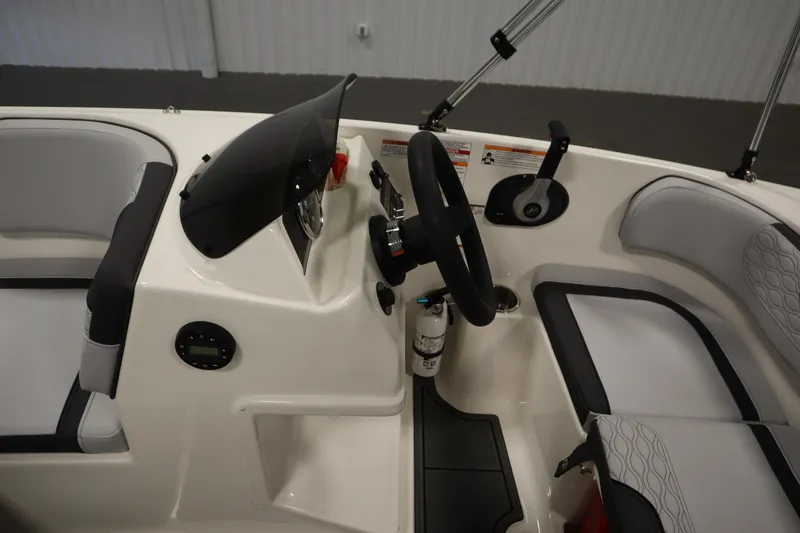 Slide: The Image of 2025 Bayliner M15 MX COMFORT PACKAGE boat interior with steering wheel and seating. - 16