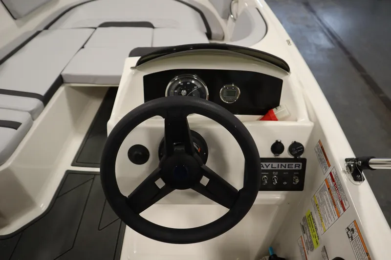 Slide: The Image of 2025 Bayliner M15 MX COMFORT PACKAGE boat dashboard with steering wheel and controls. - 17