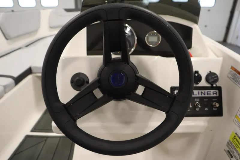 Slide: The Image of 2025 Bayliner M15 MX COMFORT PACKAGE steering wheel and dashboard controls. - 18