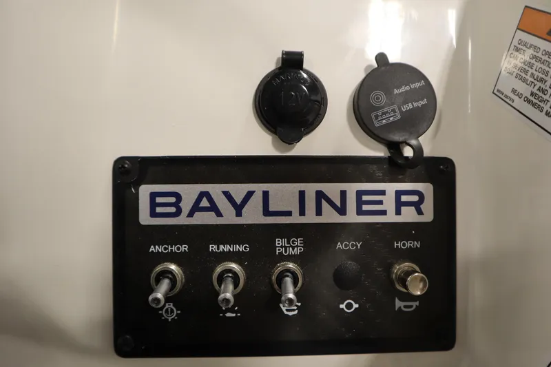 Slide: The Image of Control panel of 2025 Bayliner M15 MX COMFORT PACKAGE with switches and audio input. - 20