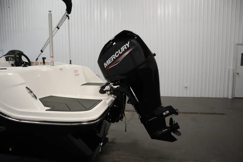 Slide: The Image of 2025 Bayliner M15 MX COMFORT PACKAGE boat with Mercury outboard motor in a showroom. - 29