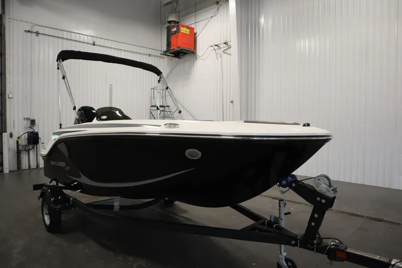Slide: The Image of 2025 Bayliner M15 MX Comfort Package boat on trailer in indoor setting. - 3