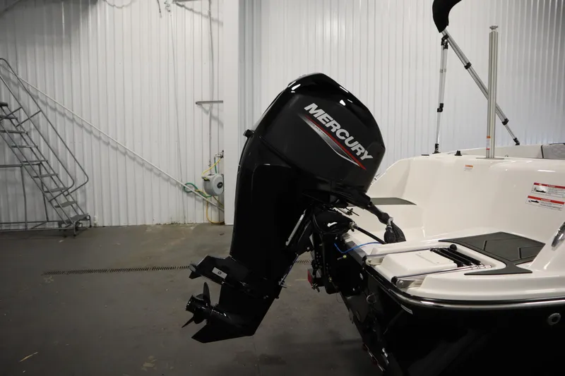 Slide: The Image of 2025 Bayliner M15 MX COMFORT PACKAGE with Mercury outboard motor in a garage setting. - 30