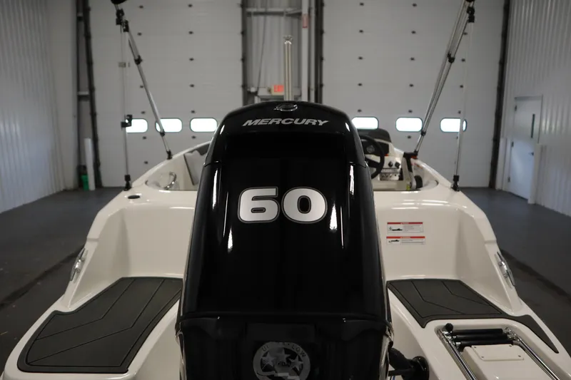 Slide: The Image of 2025 Bayliner M15 MX with Mercury 60 engine in a garage setting. - 31