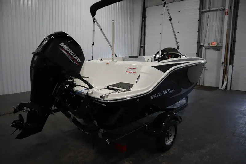 Slide: The Image of 2025 Bayliner M15 MX COMFORT PACKAGE boat with Mercury engine in a garage. - 5