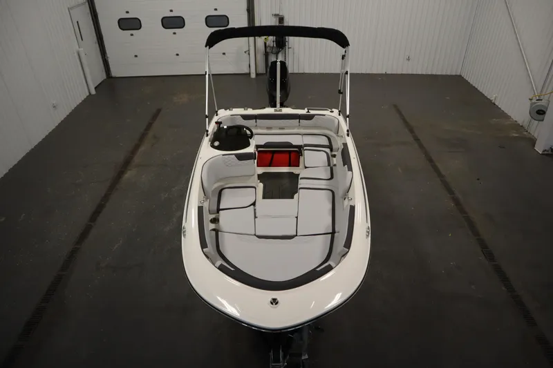 Slide: The Image of 2025 Bayliner M15 MX COMFORT PACKAGE boat in a spacious indoor setting. - 9