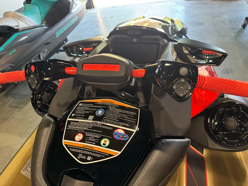 Slide: The Image of 2025 Sea-Doo RXP-X 325 jet ski dashboard with vibrant red handlebars and control panel. - 7