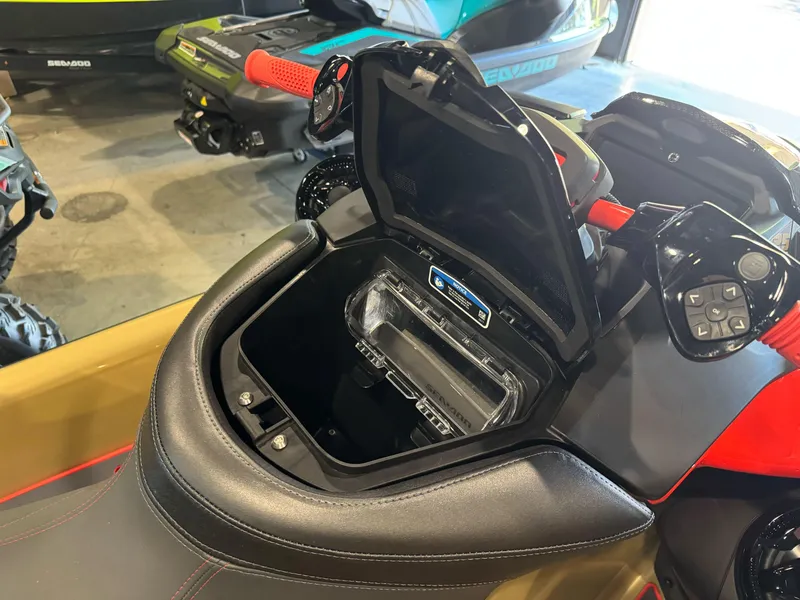 Slide: The Image of 2025 Sea-Doo RXP-X 325 storage compartment with open lid, showcasing interior features. - 8