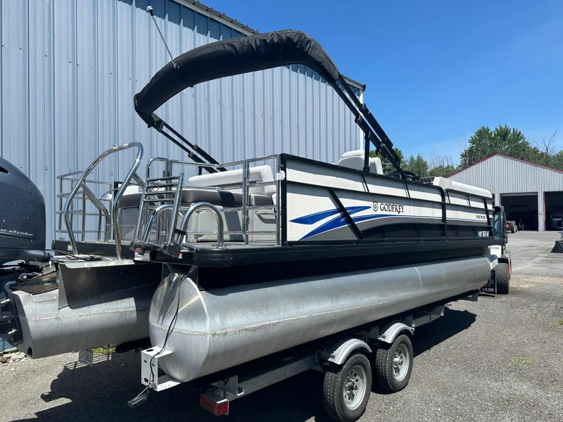 Slide: The Image of 2022 Godfrey SWEETWATER 2286 SFL pontoon boat on trailer, parked outdoors. - 5