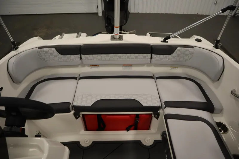 Slide: The Image of 2024 Bayliner M15 MX COMFORT PACKAGE boat interior with cushioned seating and storage. - 22