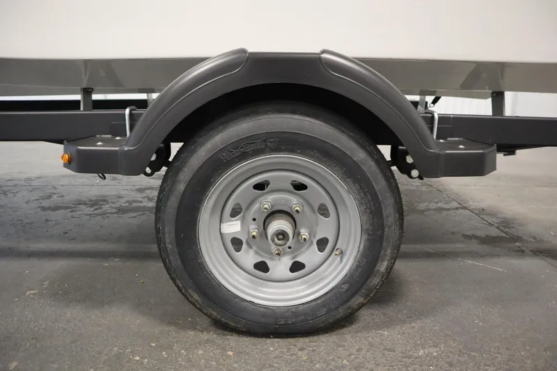 Slide: The Image of 2024 Bayliner M15 MX trailer wheel and fender on concrete floor. - 32