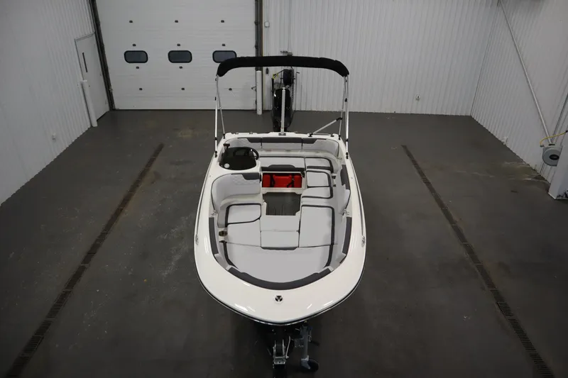 Slide: The Image of 2024 Bayliner M15 MX COMFORT PACKAGE boat in a spacious indoor setting. - 9