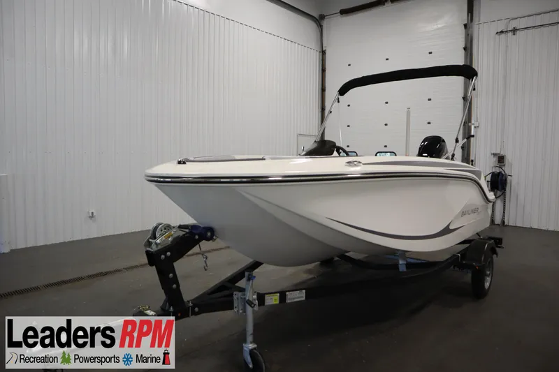 The Image of 2024 Bayliner M15 MX Comfort Package boat on trailer in indoor showroom. - 1