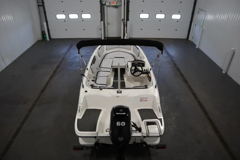 Slide: The Image of 2025 Bayliner Element M15 storage compartment, open and empty, showcasing interior space. - 10