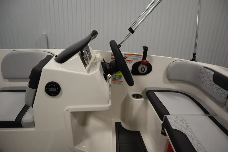 Slide: The Image of 2025 Bayliner Element M15 boat interior with steering wheel and dashboard controls. - 15