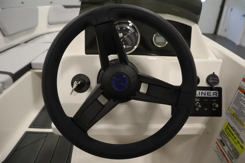 Slide: The Image of Steering wheel of 2025 Bayliner Element M15 boat, featuring dashboard controls and gauges. - 17