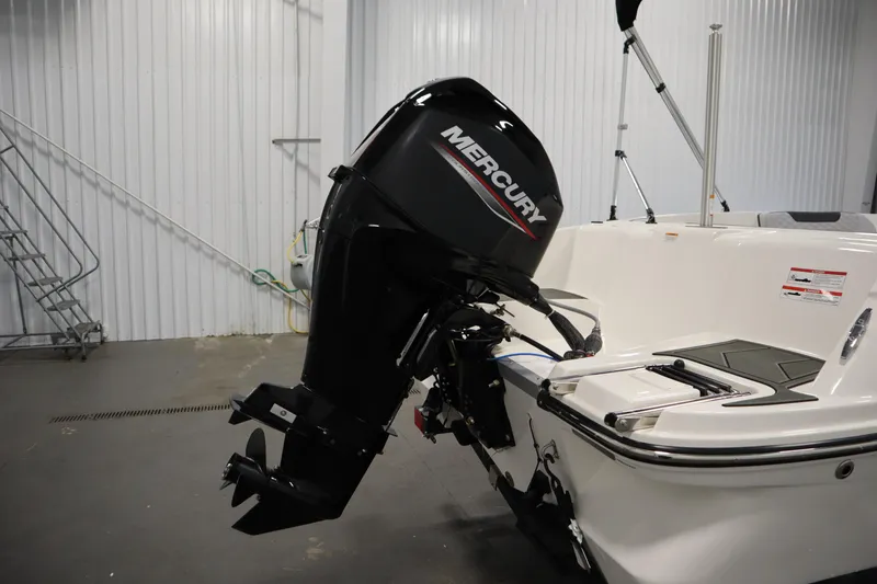 Slide: The Image of 2025 Bayliner Element M15 with Mercury outboard motor in a garage setting. - 28