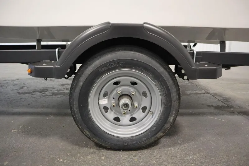 Slide: The Image of Trailer wheel of 2025 Bayliner Element M15 boat on concrete floor. - 34