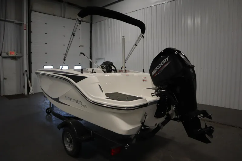 Slide: The Image of 2025 Bayliner Element M15 boat with Mercury engine in a garage setting. - 7