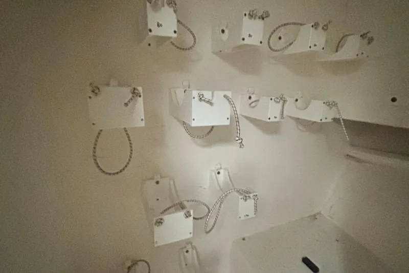 Slide: The Image of Wall-mounted white brackets with chains on a 2016 Newton Sportfish boat. - 6