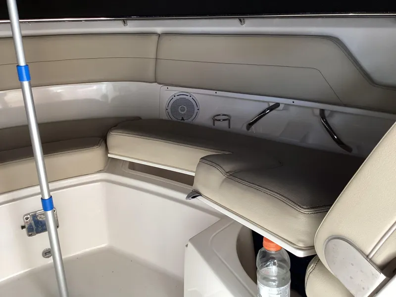 Slide: The Image of 2017 Pursuit DC 325 Dual Console interior with beige seating and storage compartments. - 12