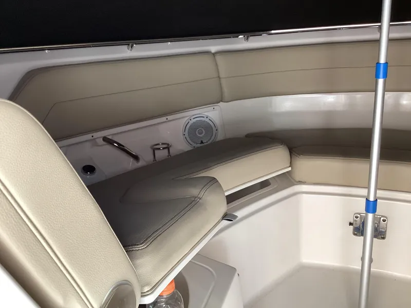 Slide: The Image of 2017 Pursuit DC 325 Dual Console interior with beige seating and speaker. - 13