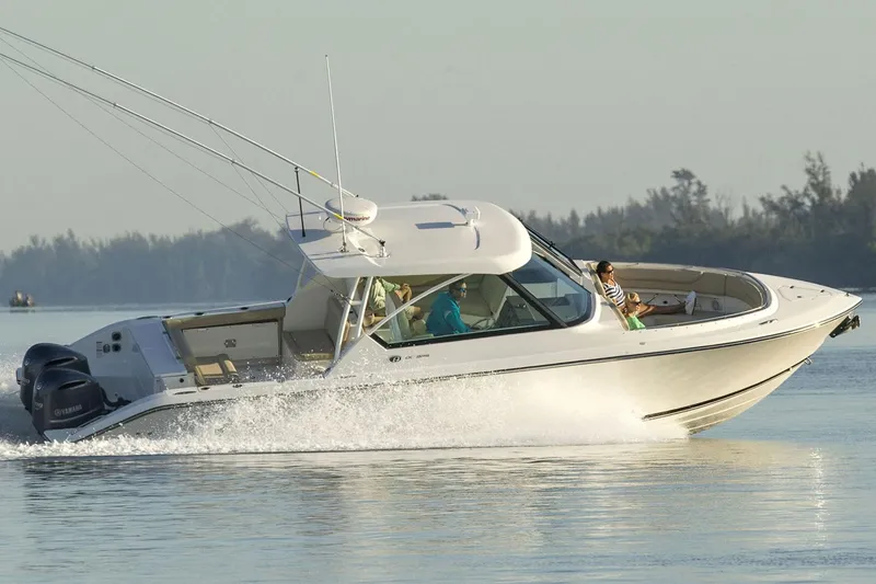 Slide: The Image of Manufacturer Provided Image: 2017 Pursuit DC 325 Dual Console boat cruising on calm water. - 2