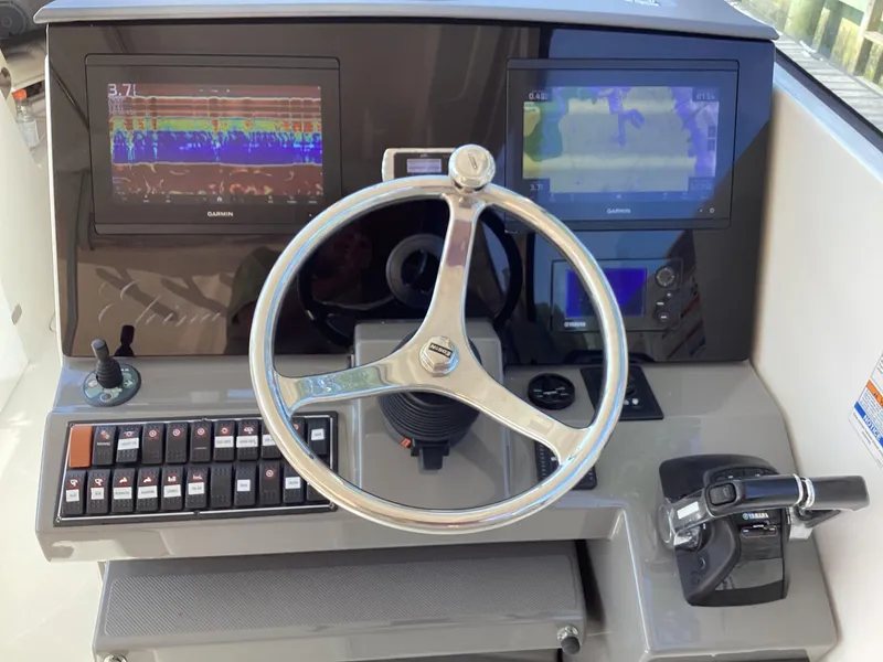 Slide: The Image of 2017 Pursuit DC 325 Dual Console helm with Garmin displays and Yamaha controls. - 22