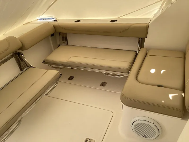 Slide: The Image of 2017 Pursuit DC 325 Dual Console interior with beige seating and speaker. - 28