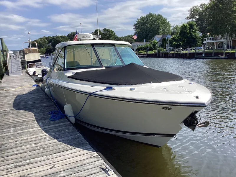 Slide: The Image of 2017 Pursuit DC 325 Dual Console boat docked on a sunny day. - 33