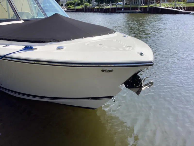 Slide: The Image of 2017 Pursuit DC 325 Dual Console boat docked on calm water. - 38