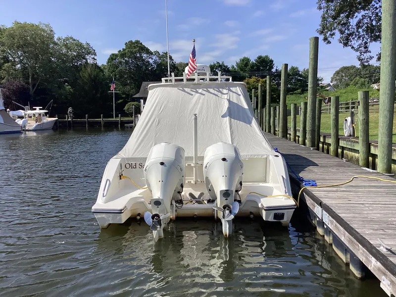 Slide: The Image of 2017 Pursuit DC 325 Dual Console boat docked with twin outboard engines. - 41