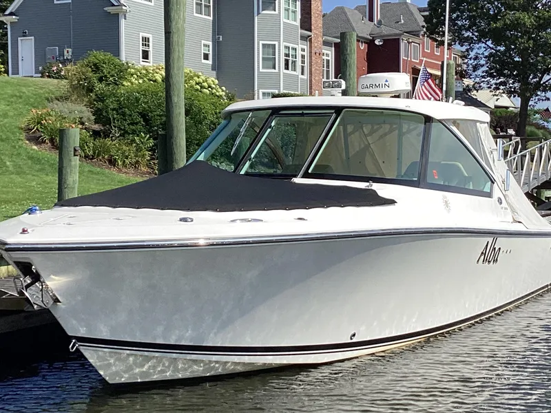 Slide: The Image of 2017 Pursuit DC 325 Dual Console boat docked near waterfront homes. - 44