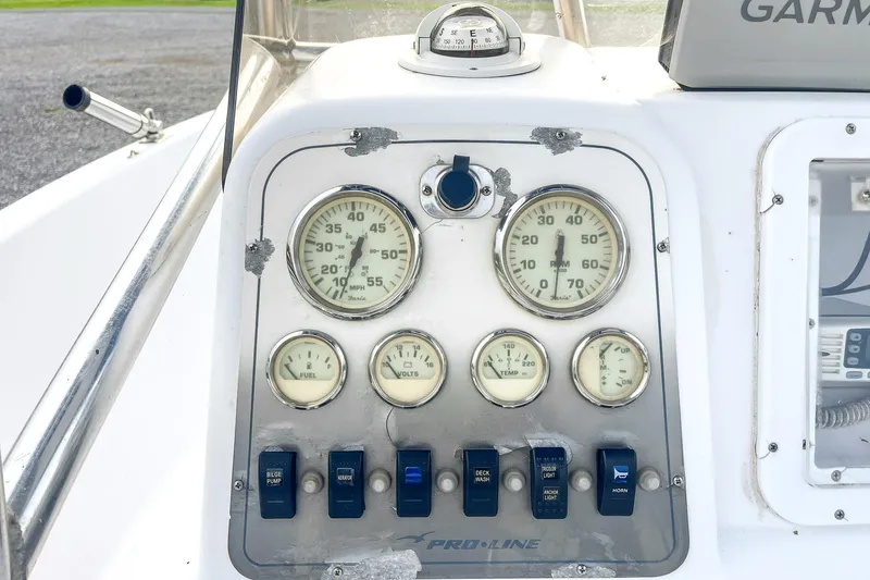 Slide: The Image of Control panel of a 2000 Pro-Line 20 Sport boat with gauges and switches. - 11