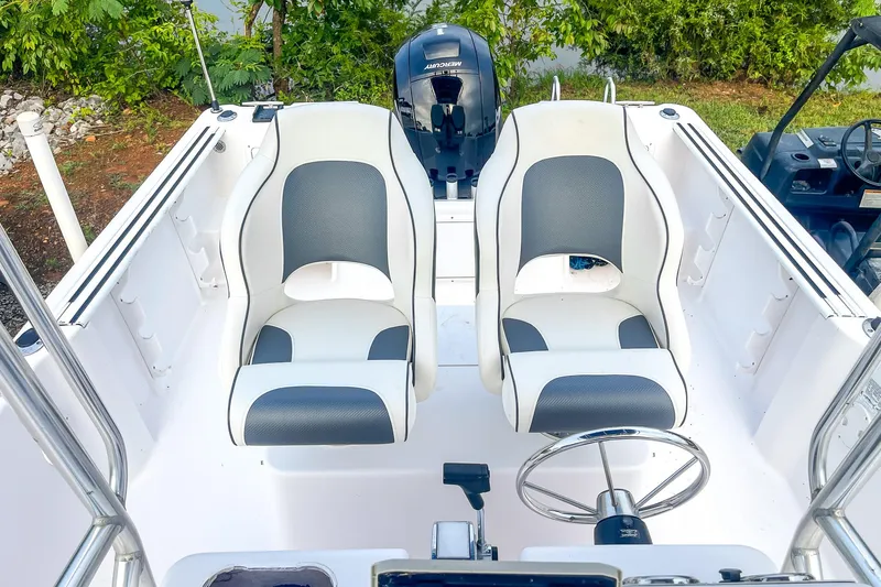 Slide: The Image of 2000 Pro-Line 20 Sport boat interior with dual seats and steering wheel. - 17