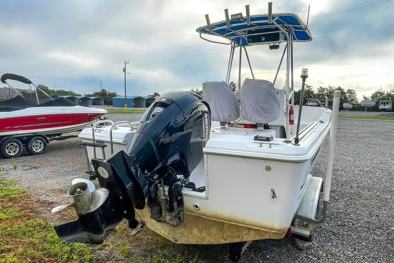 Slide: The Image of 2000 Pro-Line 20 Sport boat with outboard motor on a trailer, parked outdoors. - 7