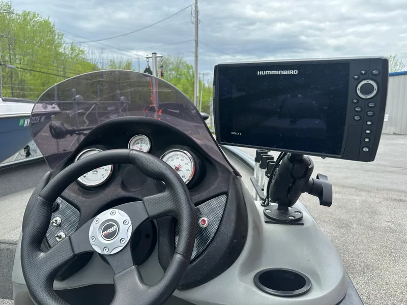 Slide: The Image of 2013 Tracker Super Guide V-16 SC dashboard with steering wheel and Humminbird Helix 8 fish finder. - 6
