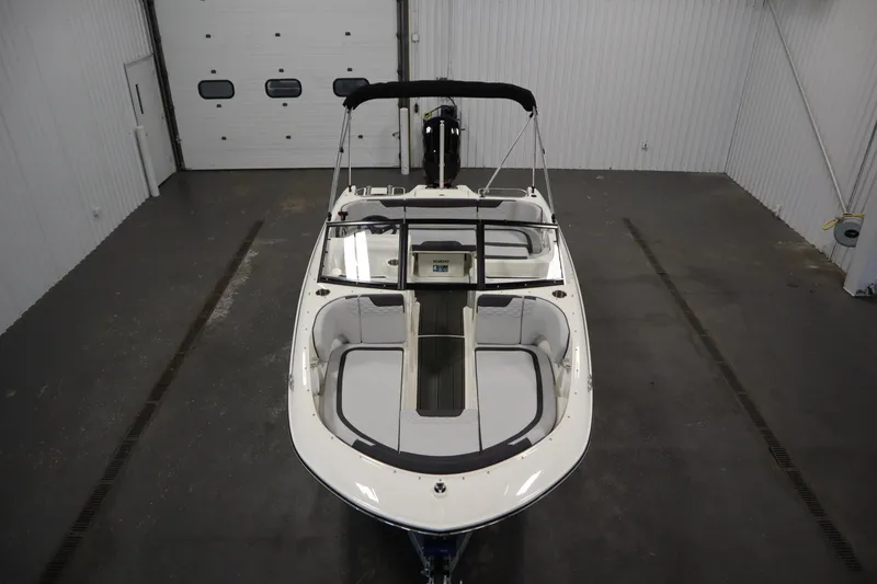 Slide: The Image of 2025 Bayliner M17 ELEMENT MX COMFORT boat in a spacious indoor showroom. - 10