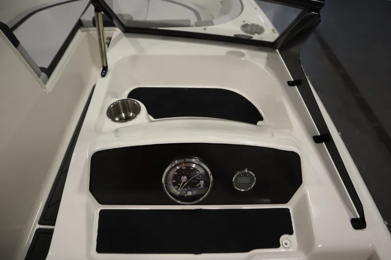 Slide: The Image of 2025 Bayliner M17 ELEMENT MX COMFORT dashboard with cup holder and gauges. - 21