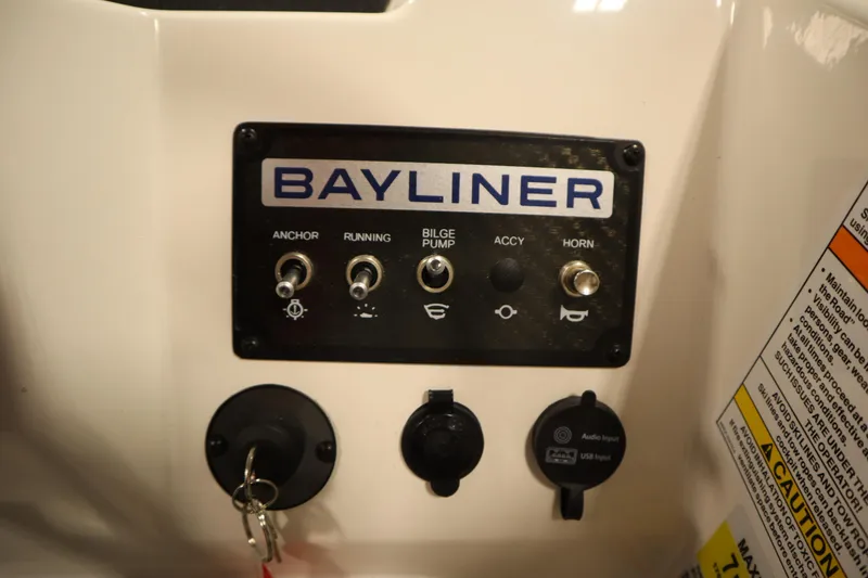 Slide: The Image of Control panel of 2025 Bayliner M17 ELEMENT MX COMFORT boat with switches and key. - 24