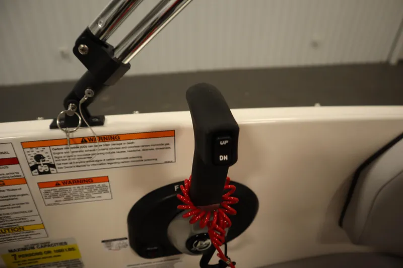 Slide: The Image of Control panel of 2025 Bayliner M17 ELEMENT MX COMFORT boat with warning labels and throttle lever. - 25