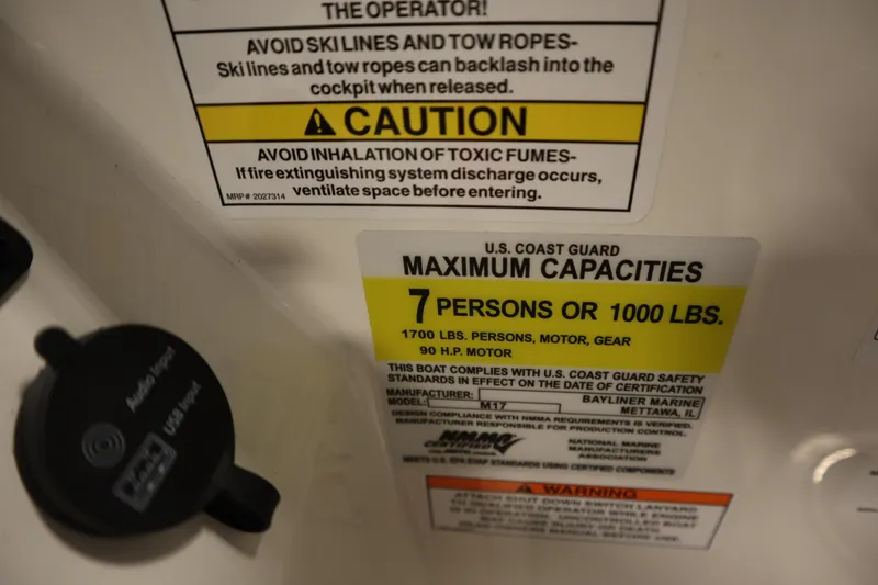Slide: The Image of Warning label on 2025 Bayliner M17 ELEMENT MX COMFORT boat, showing capacity and safety instructions. - 26