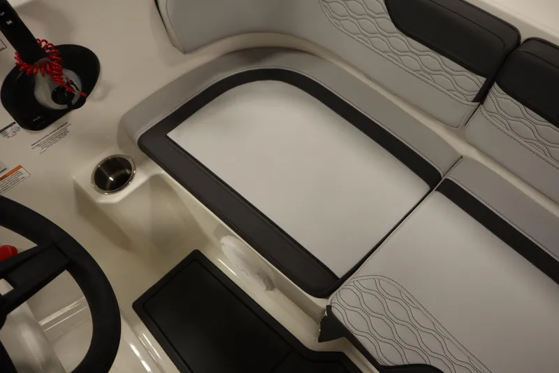 Slide: The Image of 2025 Bayliner M17 ELEMENT MX COMFORT interior seating with cup holder and steering wheel. - 33
