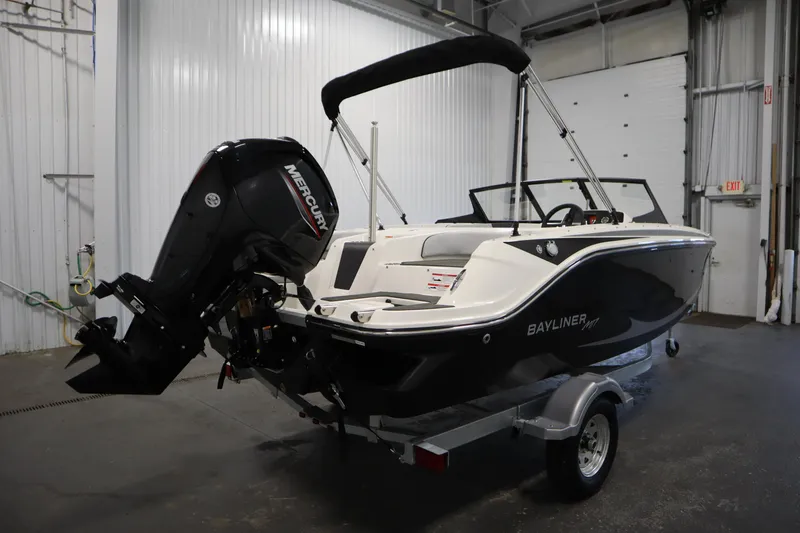 Slide: The Image of 2025 Bayliner M17 Element MX Comfort boat with Mercury engine in a garage setting. - 4