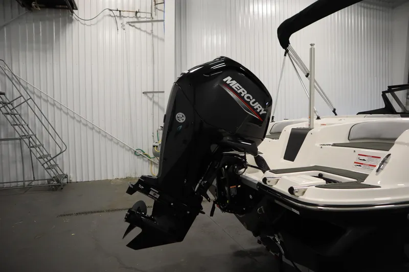 Slide: The Image of 2025 Bayliner M17 ELEMENT MX COMFORT boat with Mercury outboard motor in a garage. - 40