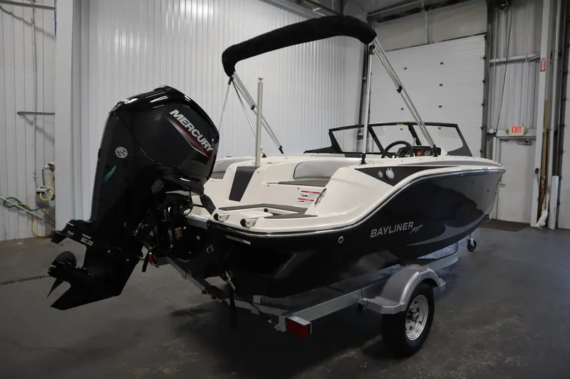 Slide: The Image of 2025 Bayliner M17 Element MX Comfort boat with Mercury engine in a garage setting. - 6