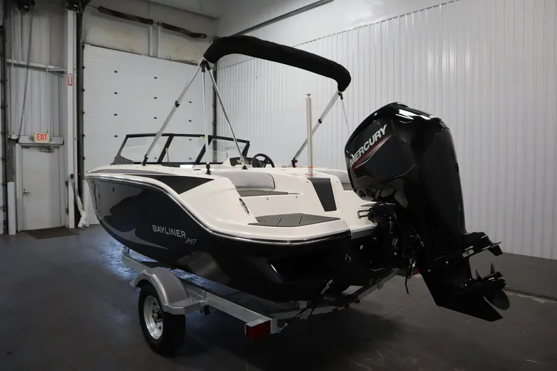Slide: The Image of 2025 Bayliner M17 Element MX Comfort boat with Mercury outboard in a garage setting. - 8